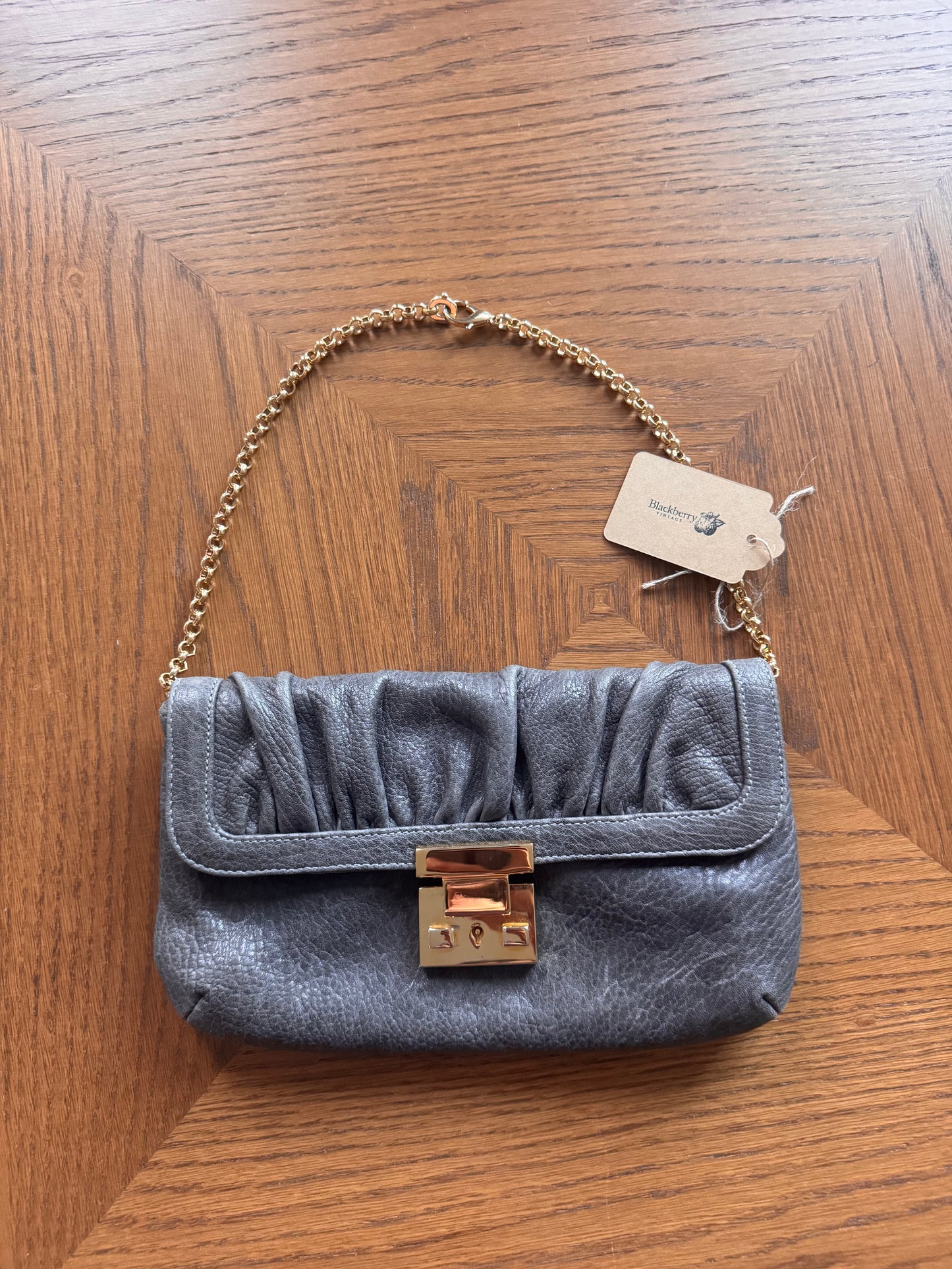 Ruched gray leather clutch