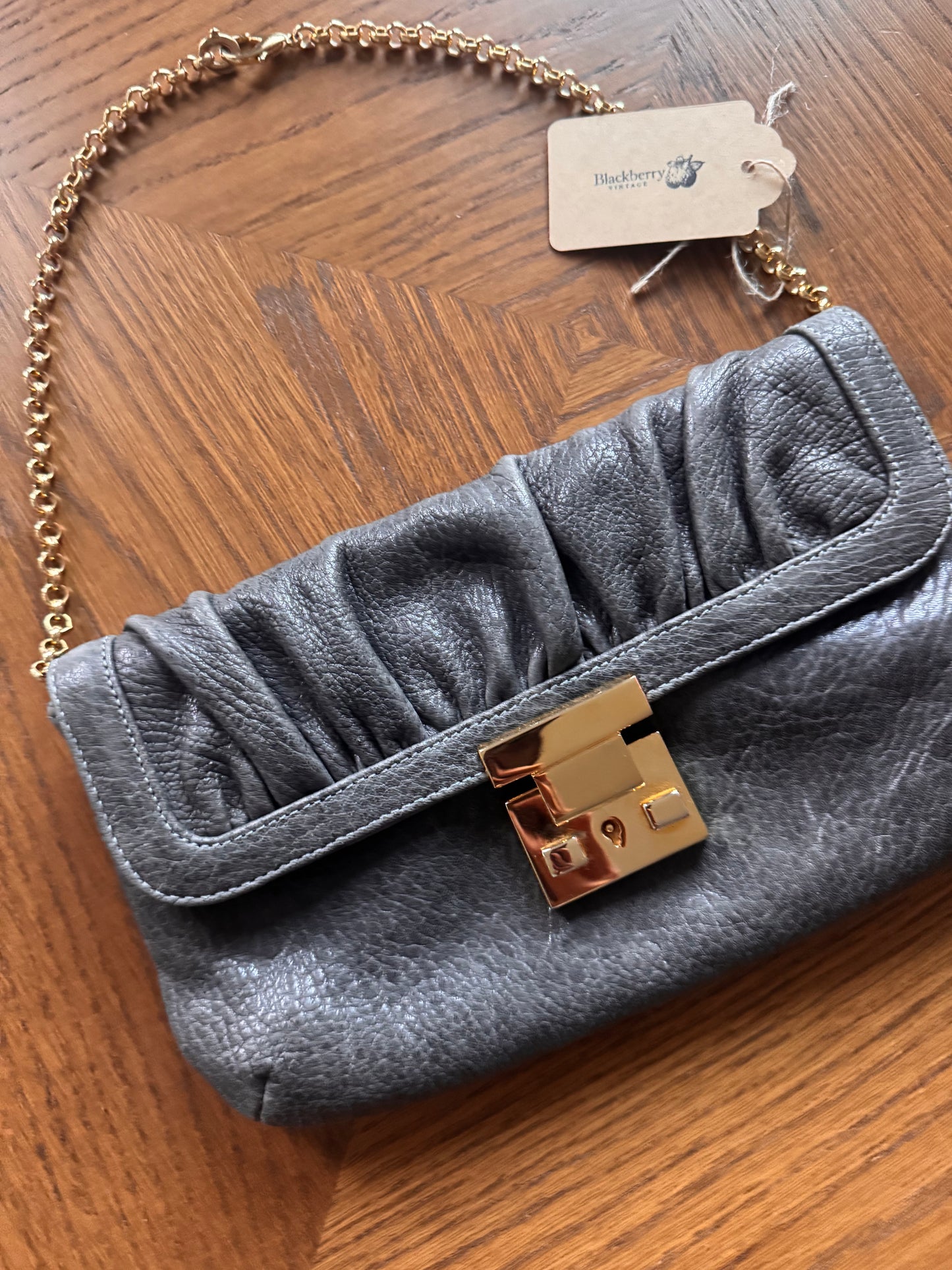 Ruched gray leather clutch