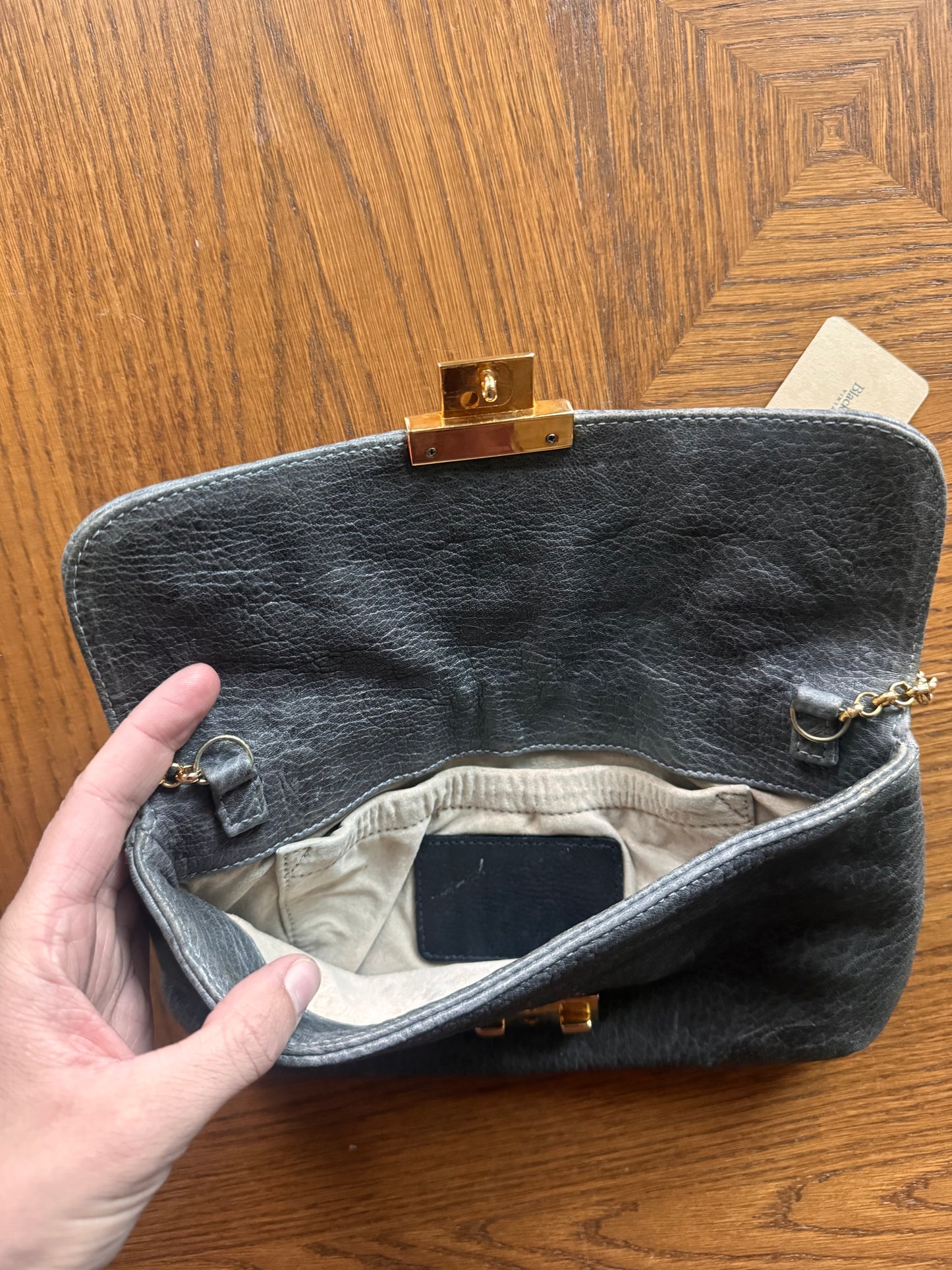 Ruched gray leather clutch